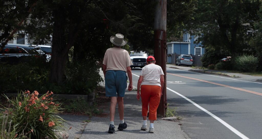 man in white t-shirt and red shorts standing beside man in white t-shirt and