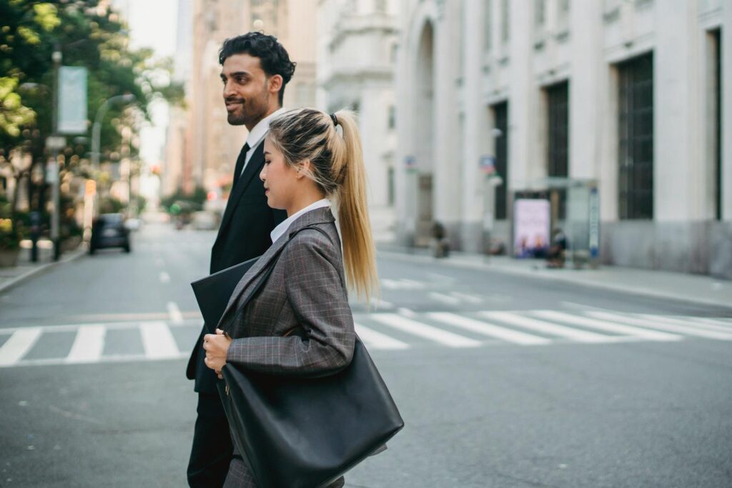 Business professionals walking confidently in a city street, showcasing teamwork and modern lifestyle.